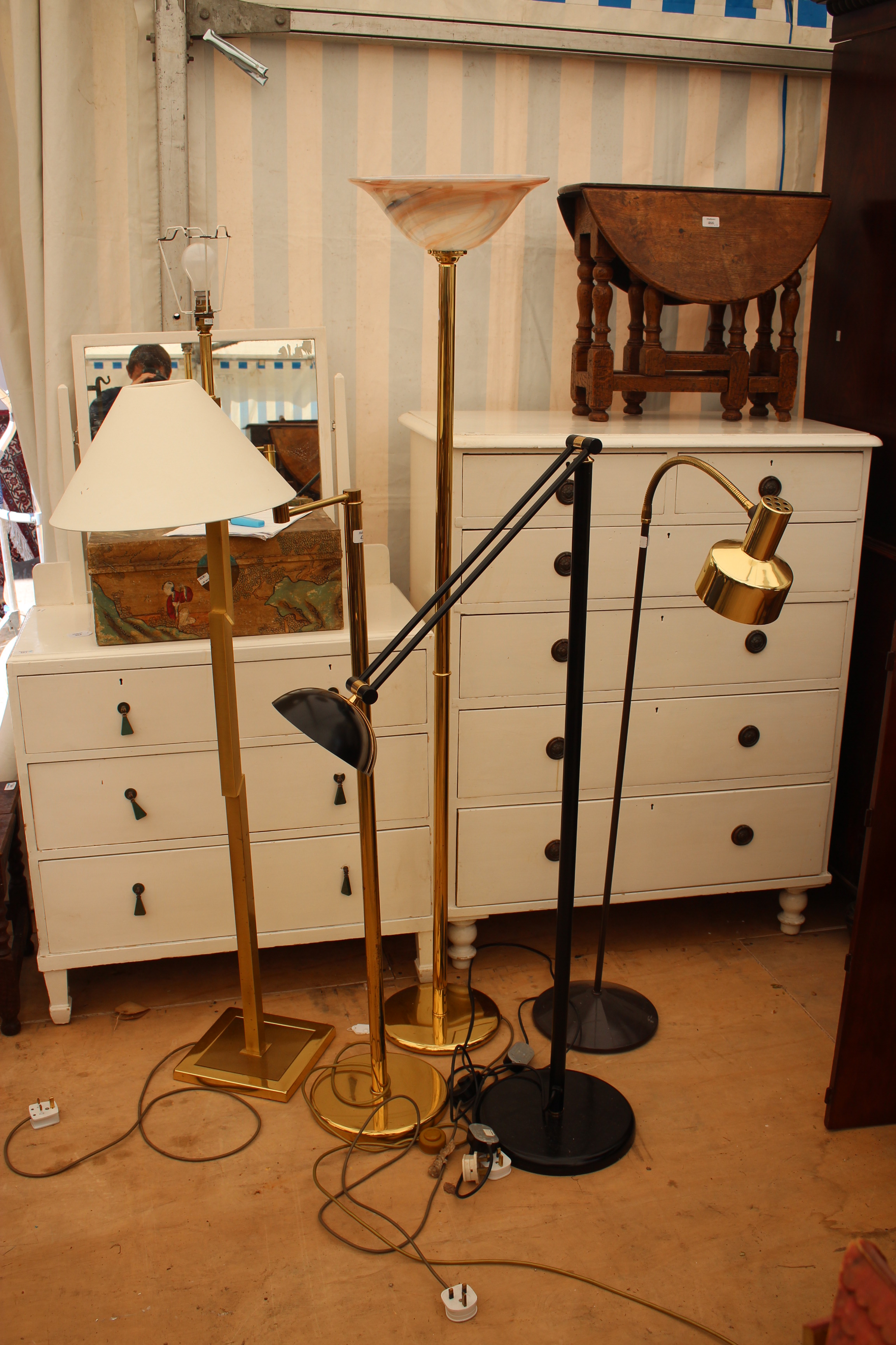 A CONTEMPORARY BRASS ADJUSTABLE STANDARD LAMP with circular base together with four further floor