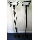 A PAIR OF PAINTED WROUGHT IRON FLOOR LAMPS with glass shades and circular spreading bases 179cm high