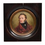 A GEORGE IV PERIOD PORTRAIT MINIATURE of a gentleman wearing a red coat 9.5cm diameter