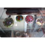 THREE OLD GLASS PAPERWEIGHTS with cane decoration, possibly French and a further glass