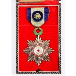 AN EARLY 20TH CENTURY CHINESE GILT METAL ENAMEL AND PEARL DECORATED MEDAL 'The Order of the Precious