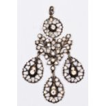 A VICTORIAN PASTE PENDANT WITH STYLISED FLOWERHEAD DESIGN and three pear shaped drops together