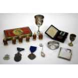 A SILVER CIGARETTE CASE together with two silver Masonic medals, a 1936 Berlin Olympic badge, a