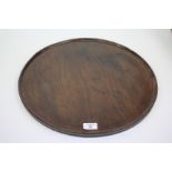 A GEORGIAN CIRCULAR MAHOGANY SALVER with moulded edge, 45cm diameter