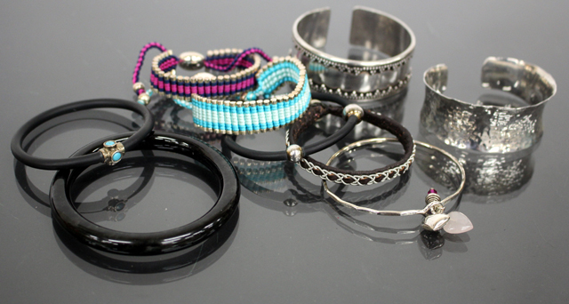 TWO SILVER AND SILK CORD DECORATED BRACELETS by Links, a silver hammered metal bracelet and other