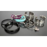 TWO SILVER AND SILK CORD DECORATED BRACELETS by Links, a silver hammered metal bracelet and other