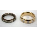 A 9 CARAT GOLD THREE STONE DIAMOND RING and a gold eternity ring (2)