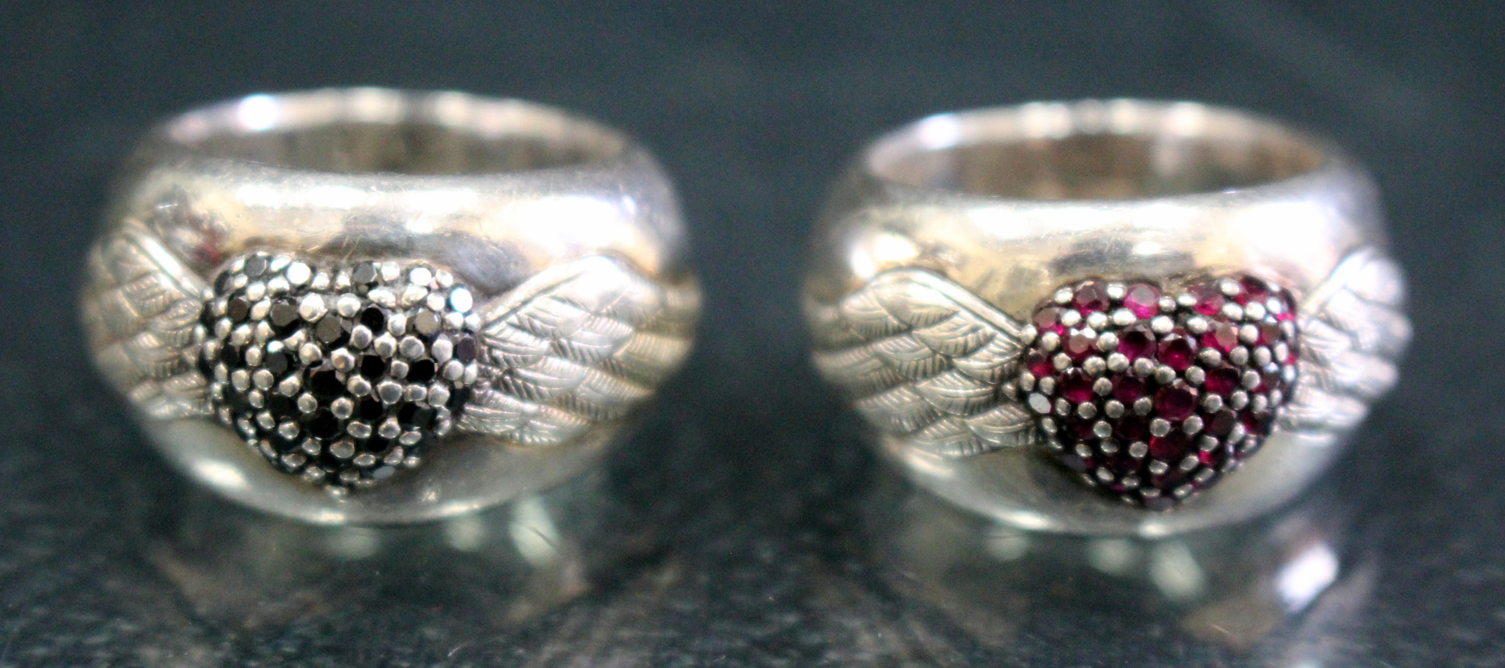 A SILVER RING by Thomas Sabo, a winged heart set with red coloured stones together with a further