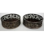 A PAIR OF 19TH CENTURY SILVER PLATED WINE BOTTLE COASTERS  with pierced fruiting vine decoration and