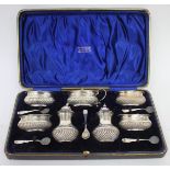 AN OLD CASED SILVER CONDIMENT SET consisting of four salt pots, a mustard pot and two pepper pots,