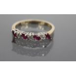 A DIAMOND AND RUBY TYPE STONE SET RING