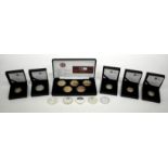 A SET OF FIVE SILVER GILT £5 COINS in a presentation case together with six silver £5 coins and four
