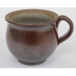 AN ANTIQUE SALT GLAZED STONEWARE SMALL CHAMBER POT with looping handle, 10cm high