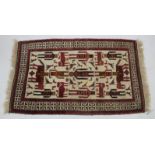 A MID TO LATE 20TH CENTURY EASTERN RED AND CREAM GROUND RUG with a banded border and figural