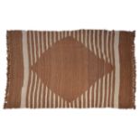 A SOUTH EAST ANATOLIAN WOVEN GOAT HAIR RUG with a plain central diamond medallion within an