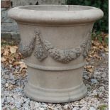 A DARK STONEWARE CIRCULAR PLANTER decorated with floral swags 53cm wide