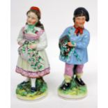 TWO 19TH CENTURY STAFFORDSHIRE POTTERY FIGURINES, a girl and a boy, each 30cm in height