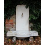 AN OTTOMAN WHITE MARBLE FOUNTAIN with carved shaped basin and a back stand with relief carved