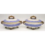 A PAIR OF WORCESTER PORCELAIN TUREENS decorated with blue and white flowers with gilt highlights and