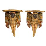 A PAIR OF 20TH CENTURY HAND PAINTED BRACKETS in the form of Blackamores with flowing robes, each