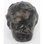 A POSSIBLY 17TH CENTURY CARVED HARDSTONE CHERUB'S HEAD approximately 10cm tall