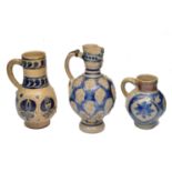 A GROUP OF THREE CONTINENTAL STONEWARE JUGS with blue glazed decoration 26 to 16cm high (3)
