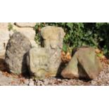 AN ANTIQUE CARVED STONE HEAD of a moustachioed gentleman, 23cm high together with a pineapple finial