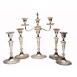 A SET OF FOUR ELECTROPLATED CANDLESTICKS with oval fluted stems and standing on conforming spreading