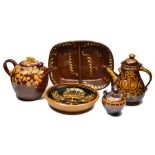 A BROWN GLAZED POTTERY LARGE TEA POT AND COVER, relief decorated and slip glazed with a frog,