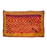 AN OLD GABBEH or village rug with chequer board decoration in blue and red dyes on a mustard