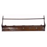 A CONTINENTAL FRUITWOOD COUNTRY MADE DELFT RACK with channel carved decoration and shaped ends,