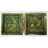 TWO 20TH CENTURY CONTINENTAL GREEN GLAZED POTTERY TILES, each depicting stags and marked 'Jgnaz