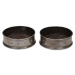 A PAIR OF LATE 20TH CENTURY SILVER AND HARDWOOD WINE BOTTLE COASTERS, marks for London and makers