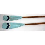 A PAIR OF PINE SCULLING OARS with blue painted blades, 366cm long (2)