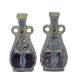 A PAIR OF ROYAL DOULTON STONEWARE VASES decorated with coloured enamels and thistles, each of shaped