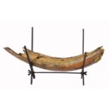 A PREHISTORIC FOSSILISED PART MAMMOTH TUSK 63cm long and mounted on a later 'X' frame support, the