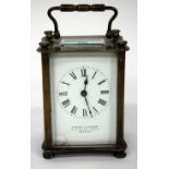 A LATE 19TH/EARLY 20TH CENTURY BRASS CARRIAGE TIMEPIECE, the enamelled dial with Roman numerals,