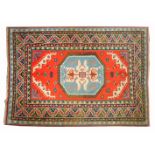 A TURKISH RED GROUND RUG with central octagonal geometric motif and further stylised floral motifs