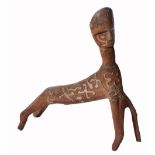A GULF OF PAPUA CARVED WOODEN FIGURE in the form of a stylised animal with pattered coat with