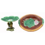 A MAJOLICA OVAL BREAD DISH, 33cm wide and a Majolica pedestal tazza supported by three cranes,