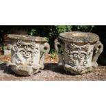 A PAIR OF ANTIQUE CARVED STONE FINIAL'S of urn form with scrolling sides and decoration, each