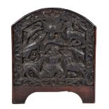 AN ASIAN HARDWOOD CARVED PANEL with arching top, the central field decorated with deity surrounded