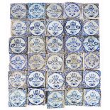 A GROUP OF 30 DUTCH DELFT TIN GLAZED TILES each depicting tulips within a lattice work border,