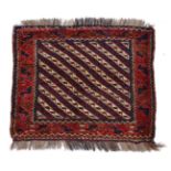 AN AFGHAN SADDLEBAG decorated with diagonal bands within a wide border 64cm x 71cm