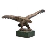 A SILVER PLATED CAR MASCOT in the form of a golden eagle with wings outstretched and standing on a