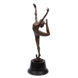 A BRONZE SCULPTURE OF A GIRL wearing a leotard and dancing on two entwined snakes and mounted on a