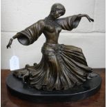 A BRONZE SCULPTURE OF A DANCING GIRL in a semi kneeling position on an oval marble base, 33cm wide