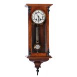 A WALNUT CASED VIENNA REGULATOR WALL CLOCK the two part enamelled dial with Roman numerals and the