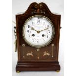 AN EDWARDIAN MAHOGANY MANTEL CLOCK, the convex white enamel Arabic dial decorated with floral