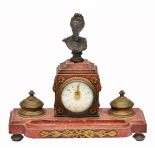 A 19TH CENTURY RED MARBLE AND ORMOLU MOUNTED MANTLE CLOCK mounted with a bronze female bust, the